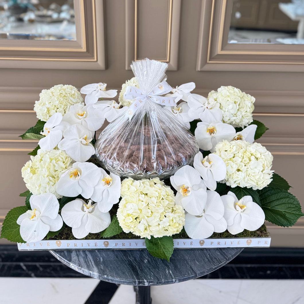 Elegant White Orchid & Hydrangeas Arrangement with Bowl of Chocolates