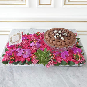 Luxury Orchids & Pink Flower Bed with Glass Bowl of Chocolates